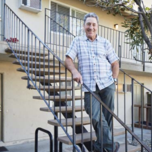 Man posing for picture on an outdoor staircase