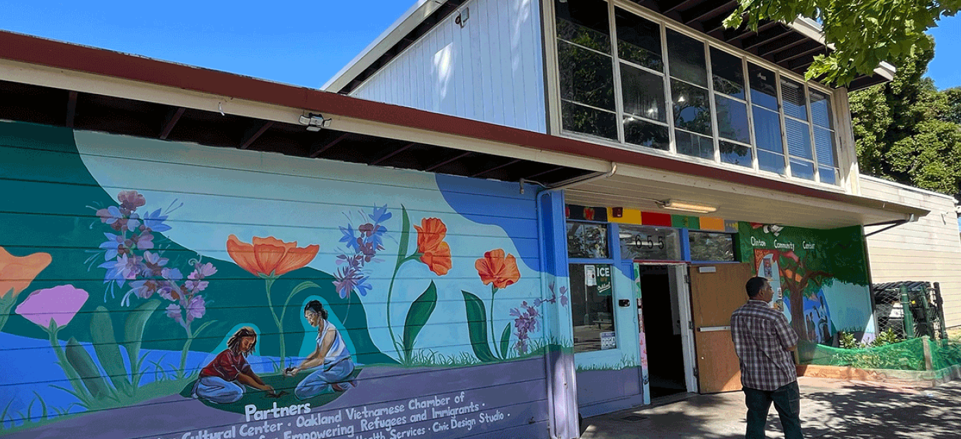 Clinton community center facade with a mural of two people planting a garden.