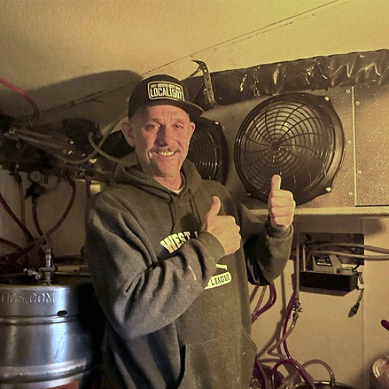 Smiling man in front of refrigeration system component.
